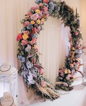 Eternal Bloom wedding arch with fresh flowers and greenery in Edmonton