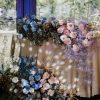 Celestial Bloom sweetheart table décor with pastel roses, blue blooms, dried flowers, and golden accents in Edmonton