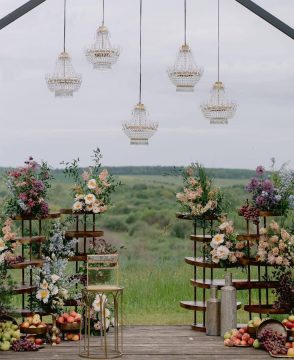 Orchard Elegance wedding ceremony setup with flowers, fruits, and chandeliers in Edmonton