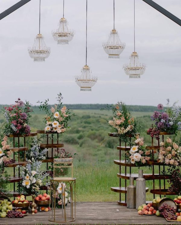 Orchard Elegance wedding ceremony setup with flowers, fruits, and chandeliers in Edmonton