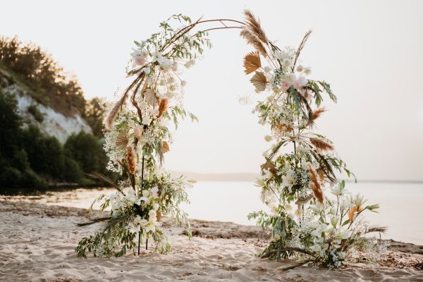 Golden Dunes wedding arch with fresh flowers, greenery, and dried elements in Edmonton