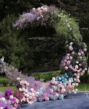 Moonlight Symphony crescent wedding arch with pastel roses, purple flowers, and celestial décor in Edmonton