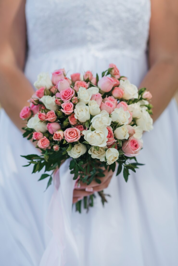 Pink and white spray rose wedding bouquet with greenery in Edmonton