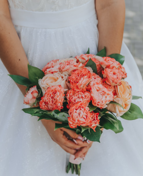 Coral Elegance wedding bouquet with coral and ivory roses and greenery in Edmonton