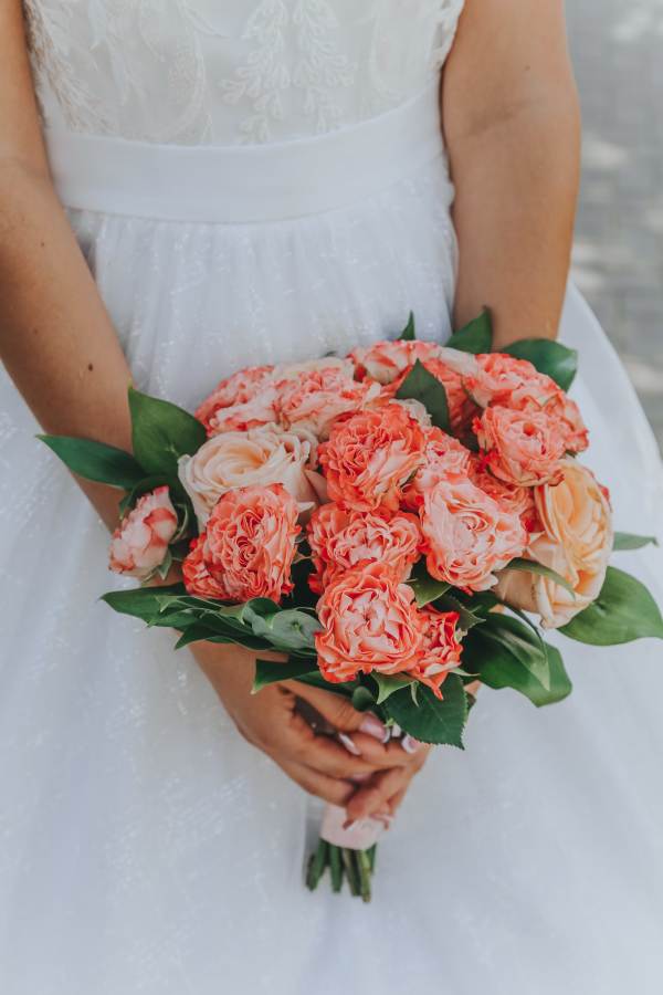 Coral Elegance wedding bouquet with coral and ivory roses and greenery in Edmonton