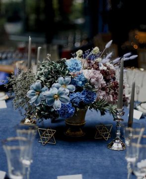 Midnight Symphony wedding table arrangement with blue and lavender flowers in Edmonton