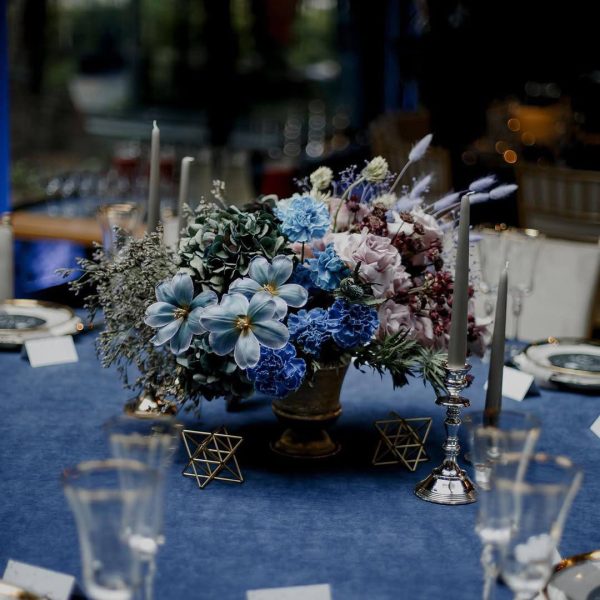 Midnight Symphony wedding table arrangement with blue and lavender flowers in Edmonton